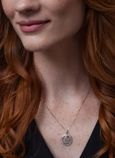 Close up shot of red haired model wearing Sterling Silver Crystal Triskele Circle Pendant